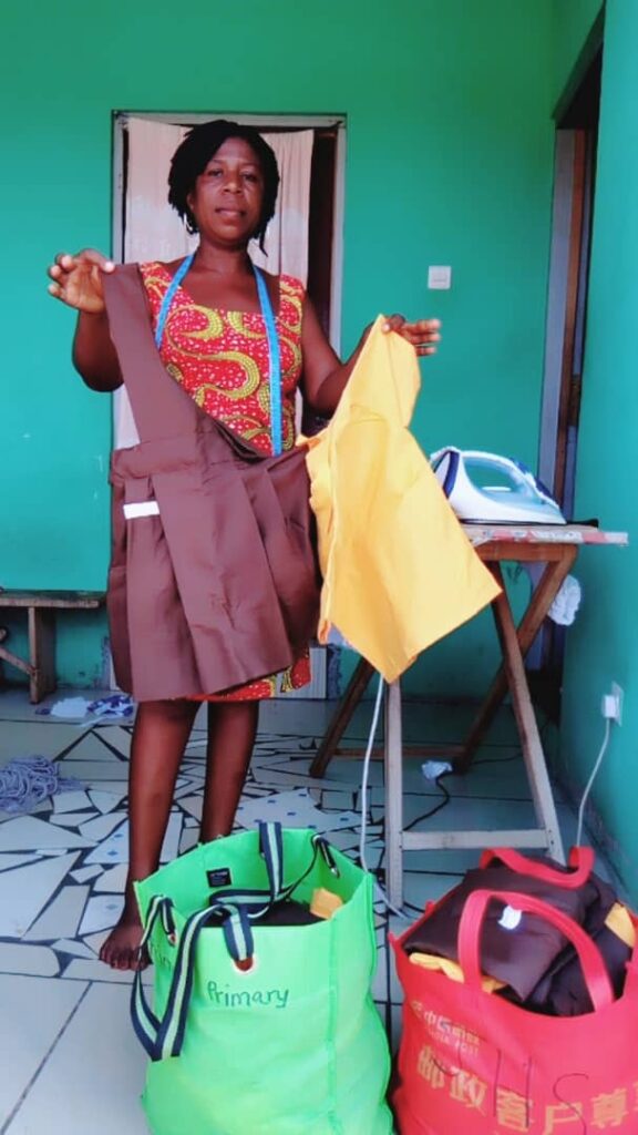 A woman holding up an apron and a yellow cloth.