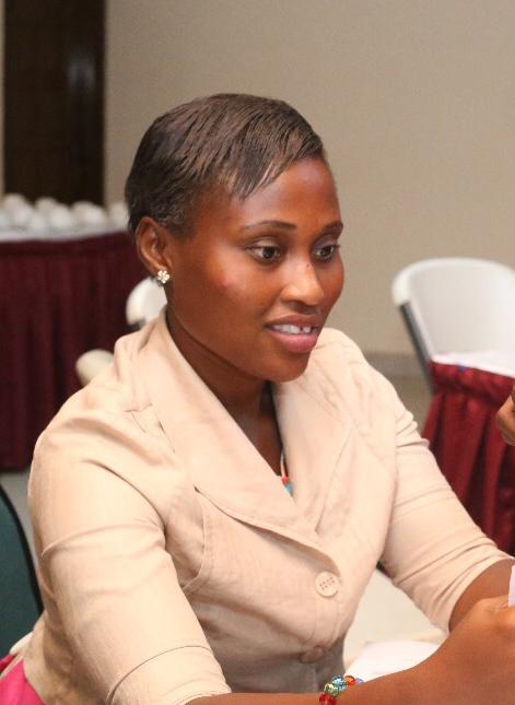 A woman sitting at a table with a smile on her face.